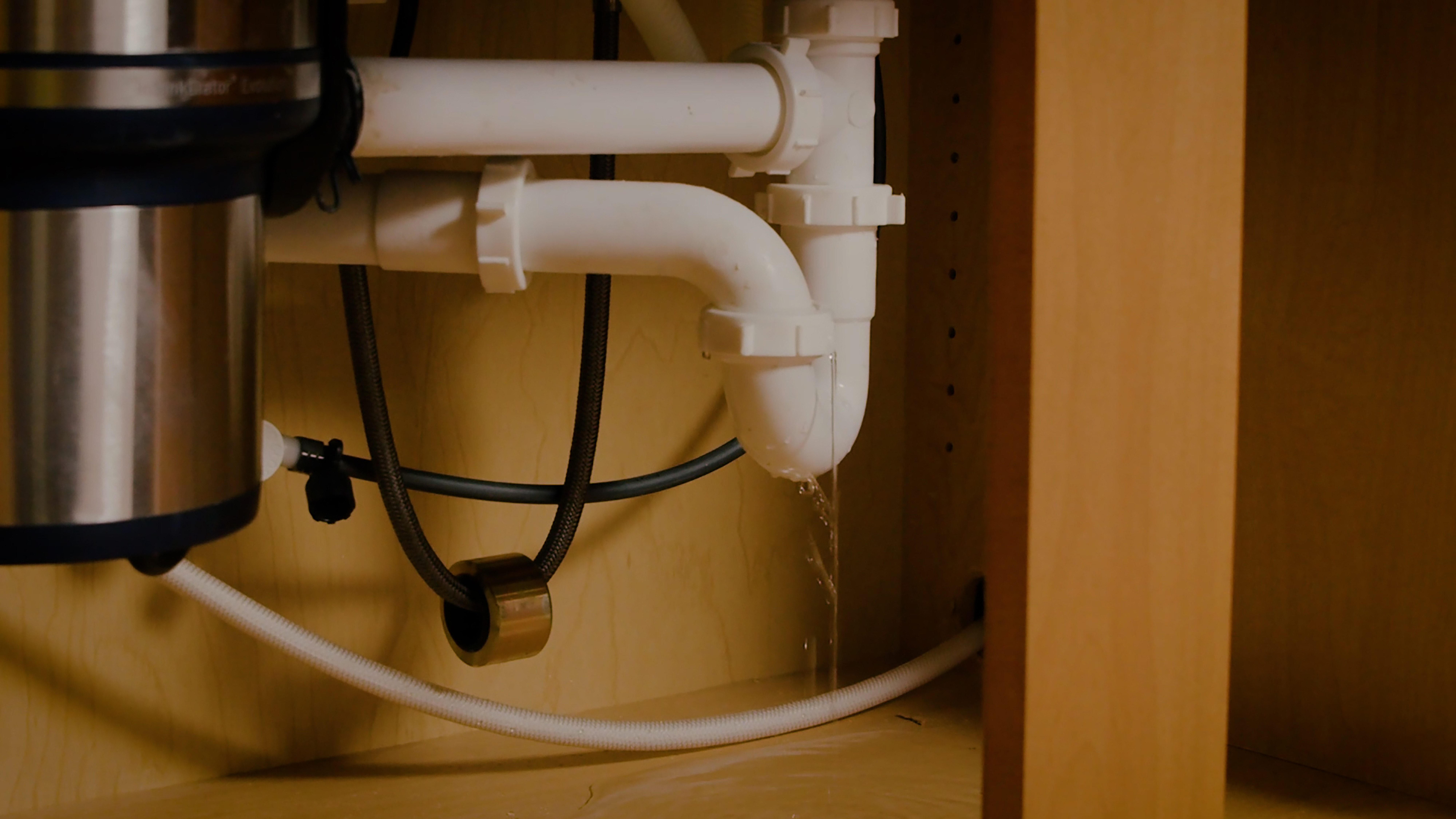 Water damage under sink due to drainage leak